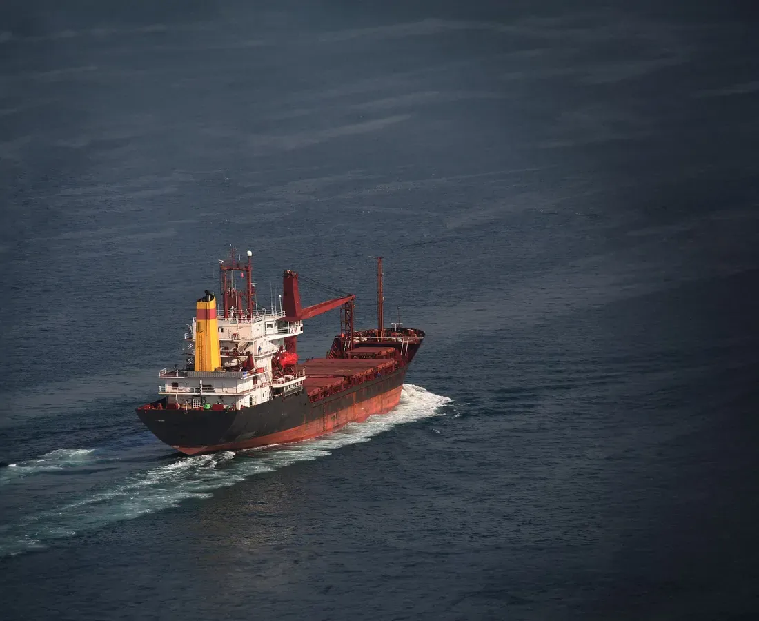 General cargo ship under way with her cranes stowed